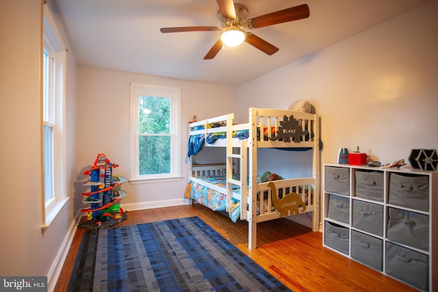 bedroom featuring baseboards, ceiling fan, and wood finished floors