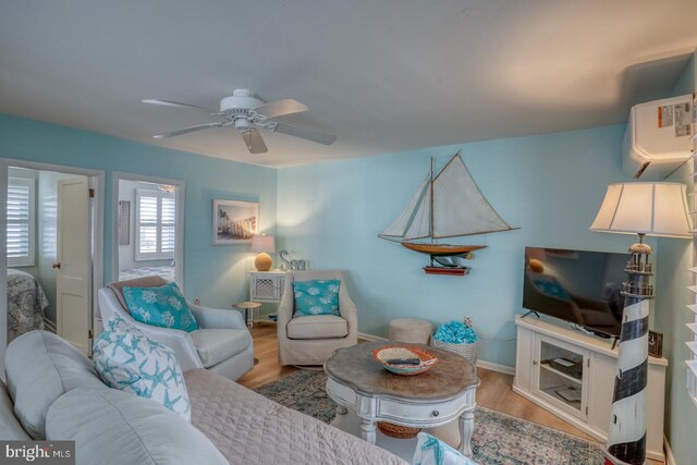 2 E Atlantic St Unit 1, Fenwick Island, DE 19944 - living area featuring wood finished floors, ceiling fan, baseboards, and a wall unit AC