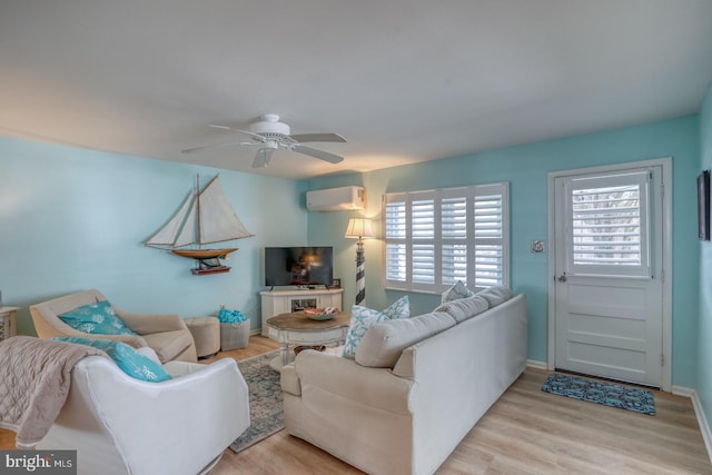 2 E Atlantic St Unit 1, Fenwick Island, DE 19944 - living room with a wall unit AC, a ceiling fan, and light wood-type flooring