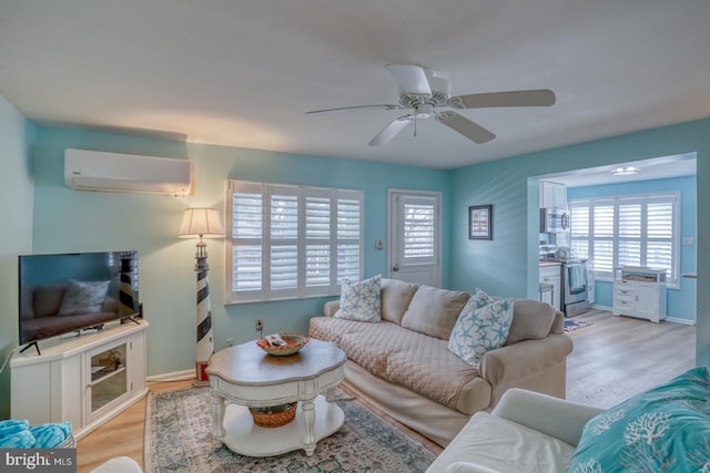 2 E Atlantic St Unit 1, Fenwick Island, DE 19944 - living area with a wall unit AC, light wood-style flooring, and healthy amount of natural light
