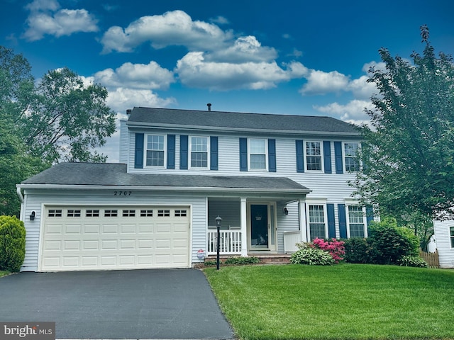 view of front facade with covered porch, aphalt driveway, a garage, and a front yard
