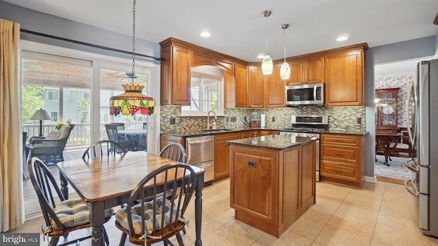 2707 Maynard Rd, Crofton, MD 21114 - kitchen with appliances with stainless steel finishes, a sink, a center island, brown cabinets, and decorative light fixtures