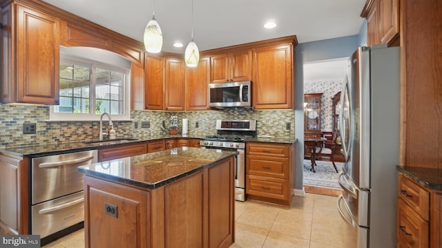 2707 Maynard Rd, Crofton, MD 21114 - kitchen featuring stainless steel appliances, a sink, brown cabinets, light tile patterned floors, and dark stone countertops