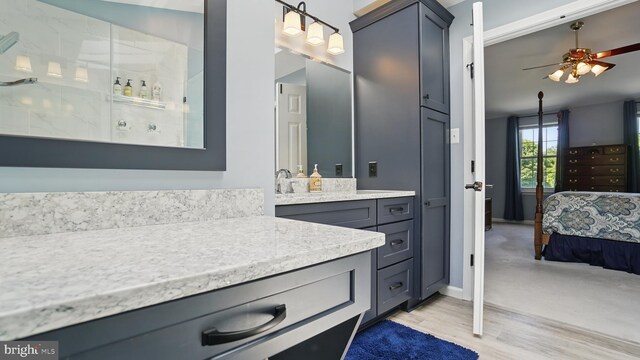 2707 Maynard Rd, Crofton, MD 21114 - bathroom featuring a ceiling fan, ensuite bath, vanity, a walk in shower, and wood finished floors