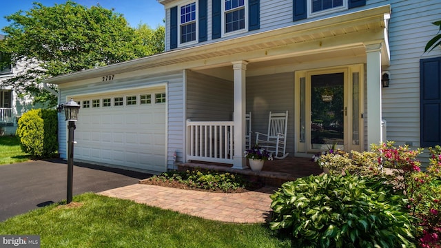 2707 Maynard Rd, Crofton, MD 21114 - doorway to property featuring covered porch, asphalt driveway, and an attached garage