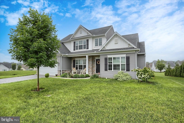 44 Danbury Dr, Mechanicsburg, PA 17050 - craftsman house featuring board and batten siding, a porch, a front lawn, driveway, and stone siding