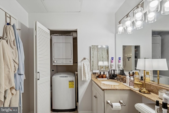 bathroom with stacked washer / drying machine and vanity