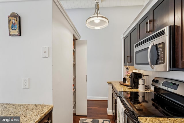 kitchen featuring stainless steel appliances, dark wood-type flooring, light stone counters, dark brown cabinets, and beam ceiling