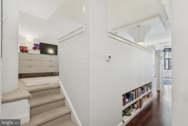 stairway featuring wood finished floors and baseboards