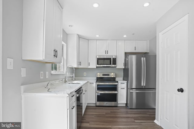 3104 Dynasty Dr, District Heights, MD 20747 - kitchen featuring appliances with stainless steel finishes, dark wood finished floors, white cabinetry, recessed lighting, and a sink