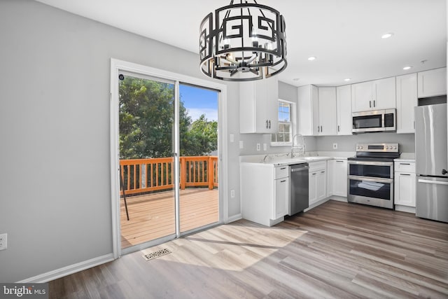 3104 Dynasty Dr, District Heights, MD 20747 - kitchen with appliances with stainless steel finishes, light countertops, white cabinetry, and recessed lighting