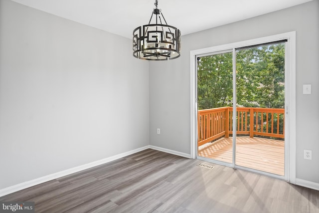 3104 Dynasty Dr, District Heights, MD 20747 - unfurnished dining area featuring wood finished floors, baseboards, and a chandelier