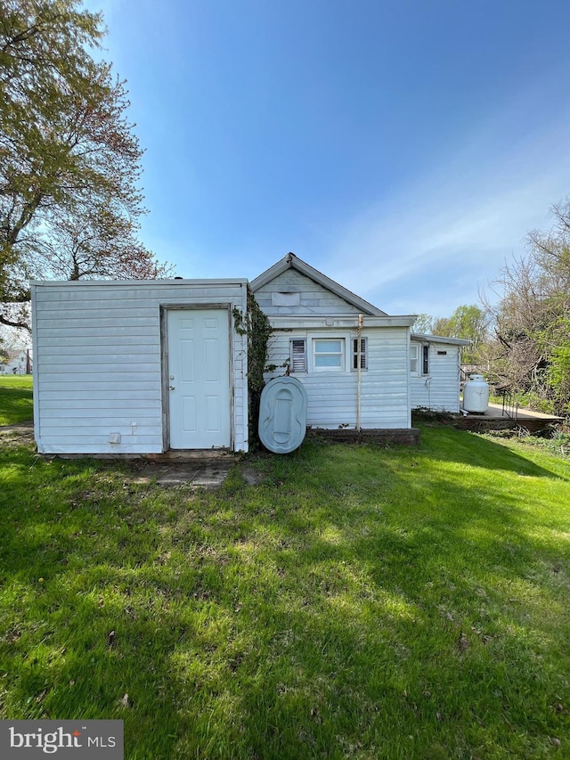 back of house with a yard