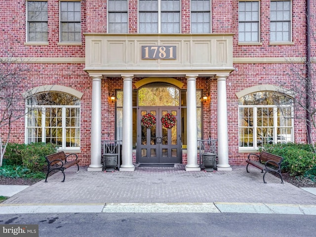 property entrance featuring brick siding