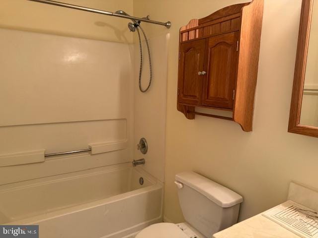 bathroom with toilet,  shower combination, and vanity