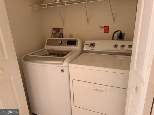washroom with washing machine and dryer and laundry area