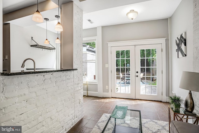1326 Otis Pl NW, Washington, DC 20010 - doorway to outside with french doors, tile patterned floors, and a sink
