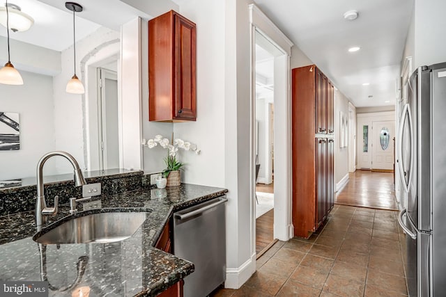 1326 Otis Pl NW, Washington, DC 20010 - kitchen featuring appliances with stainless steel finishes, a sink, reddish brown cabinets, baseboards, and recessed lighting