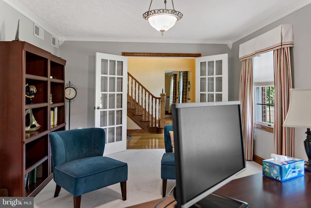office area with french doors, crown molding, and wood finished floors