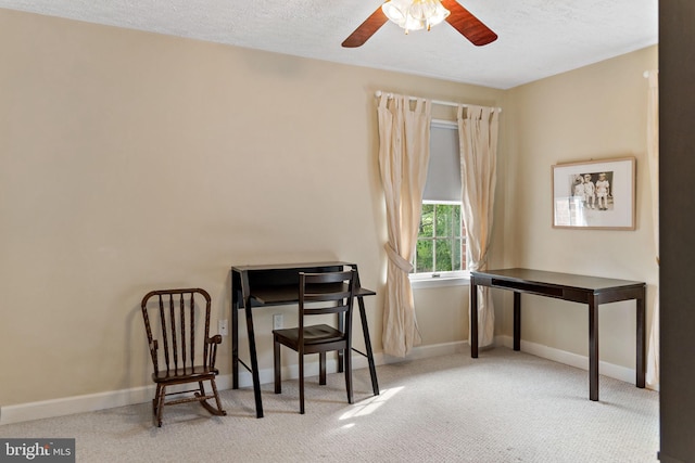 office area with carpet, baseboards, a ceiling fan, and a textured ceiling