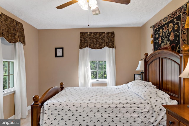 bedroom with a textured ceiling and a ceiling fan