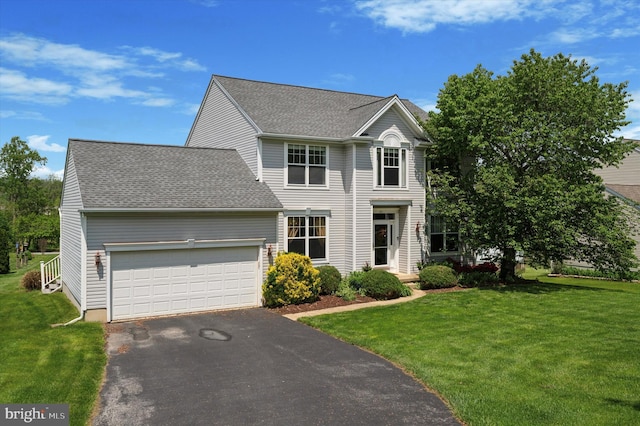 view of front facade featuring driveway, a garage, a front yard, and a shingled roof