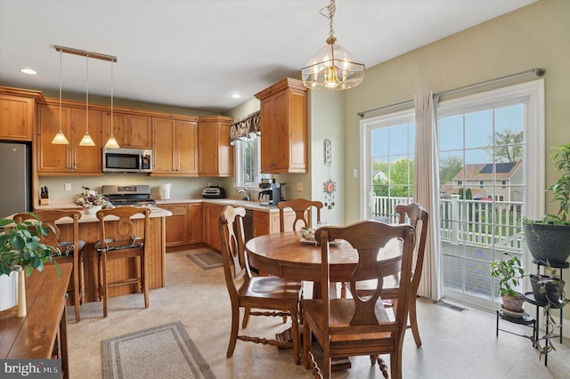 dining room featuring healthy amount of natural light, a chandelier, and recessed lighting