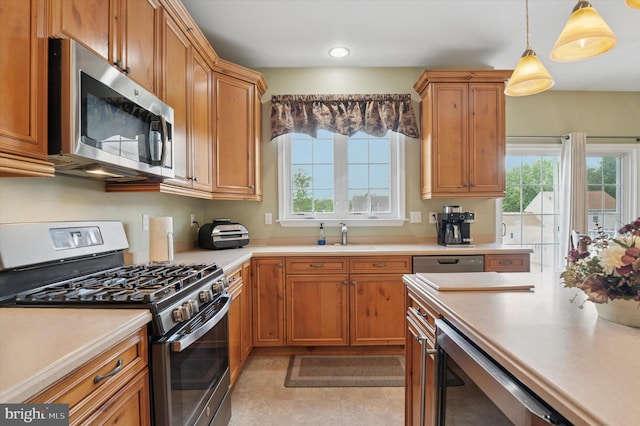 kitchen featuring stainless steel appliances, plenty of natural light, and light countertops
