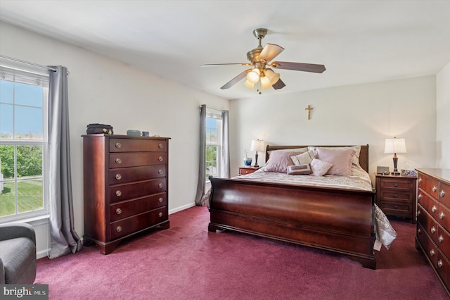 bedroom with multiple windows, carpet floors, a ceiling fan, and baseboards