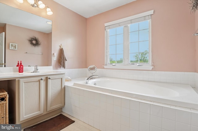 full bath with vanity and a garden tub