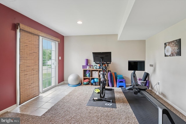 workout area featuring baseboards, light tile patterned floors, and recessed lighting
