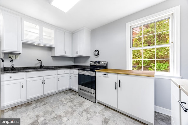 1417 Glendale Rd, Baltimore, MD 21239 - kitchen featuring electric range, a sink, white cabinets, glass insert cabinets, and dark stone counters