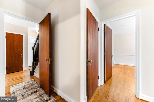 1417 Glendale Rd, Baltimore, MD 21239 - corridor with light wood-type flooring, stairs, and baseboards