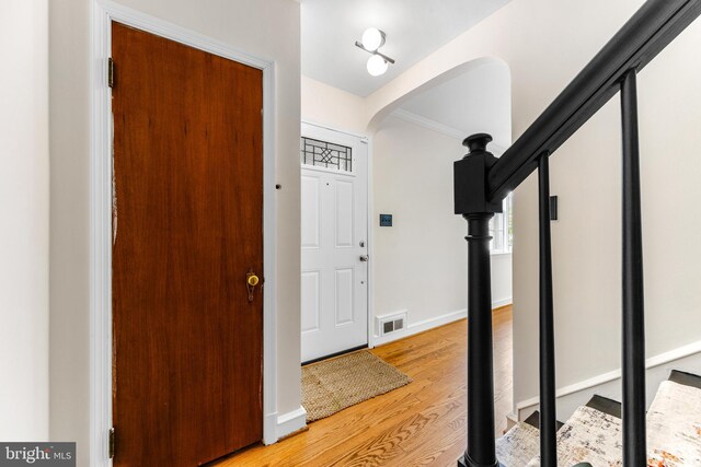 1417 Glendale Rd, Baltimore, MD 21239 - entrance foyer with arched walkways, light wood finished floors, baseboards, and stairway