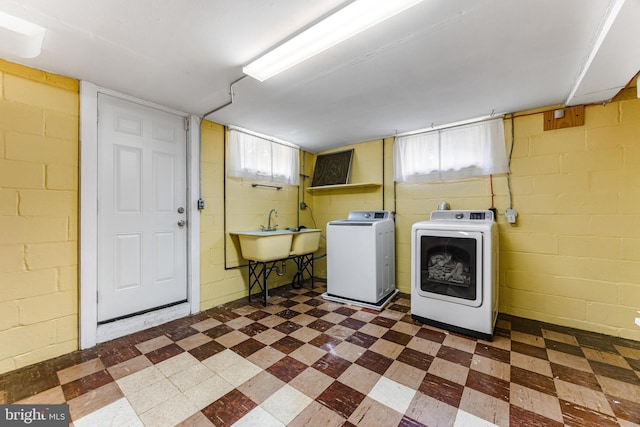 1417 Glendale Rd, Baltimore, MD 21239 - laundry room with dark flooring, washer and clothes dryer, and concrete block wall
