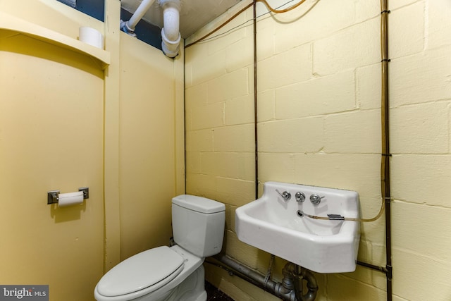 1417 Glendale Rd, Baltimore, MD 21239 - half bath with concrete block wall, toilet, and a sink