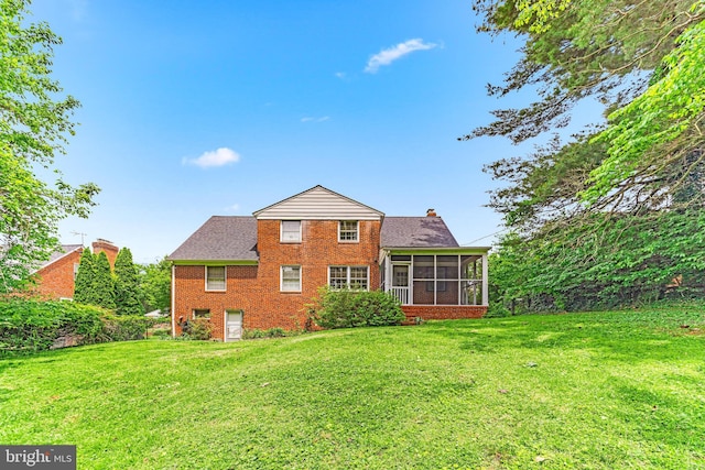 1417 Glendale Rd, Baltimore, MD 21239 - rear view of property with a sunroom, brick siding, a lawn, and a chimney