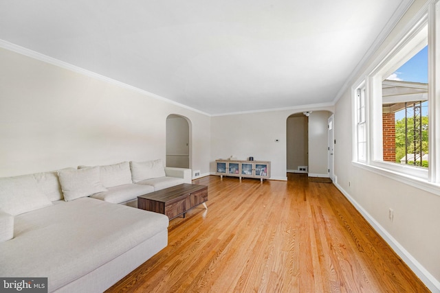 1417 Glendale Rd, Baltimore, MD 21239 - living area with arched walkways, light wood finished floors, baseboards, and ornamental molding