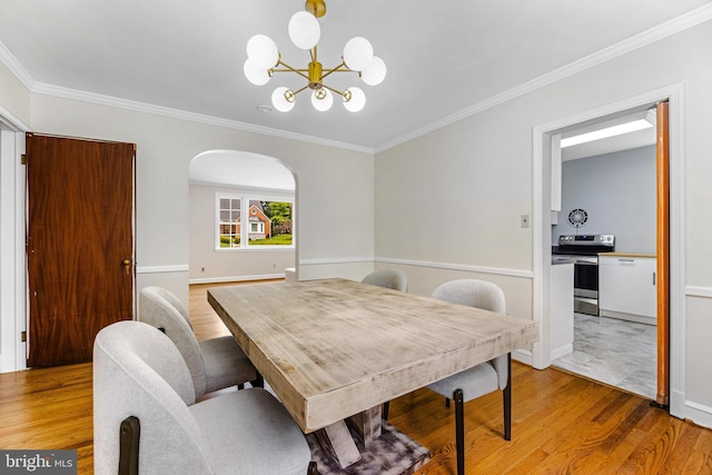 1417 Glendale Rd, Baltimore, MD 21239 - dining room with light wood-style flooring, a chandelier, ornamental molding, baseboards, and arched walkways