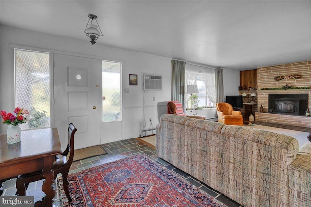 70 Miller Rd, Kutztown, PA 19530 - living area with a fireplace, a baseboard radiator, a wall unit AC, and stone tile floors