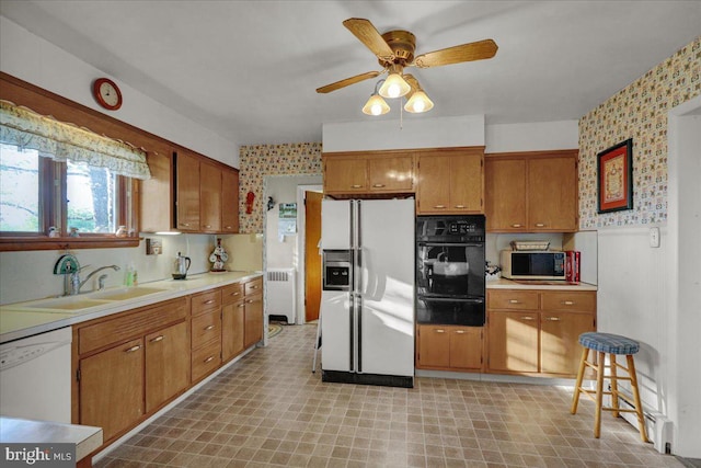 70 Miller Rd, Kutztown, PA 19530 - kitchen featuring a sink, white appliances, wallpapered walls, brown cabinetry, and a warming drawer