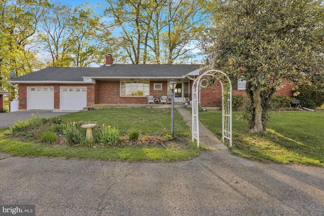 70 Miller Rd, Kutztown, PA 19530 - ranch-style house featuring a front yard, brick siding, aphalt driveway, and a garage