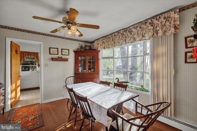 70 Miller Rd, Kutztown, PA 19530 - dining area featuring ceiling fan, wood finished floors, wallpapered walls, and a baseboard heating unit