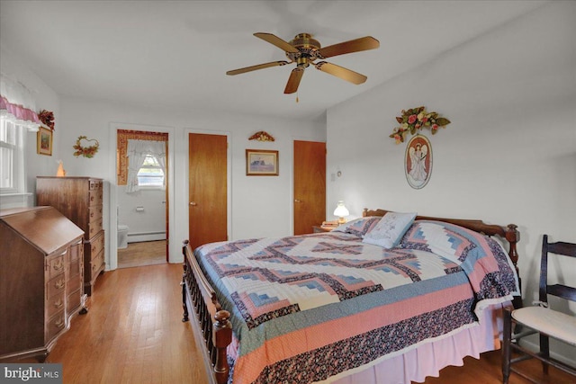 70 Miller Rd, Kutztown, PA 19530 - bedroom with light wood finished floors, ensuite bath, a ceiling fan, and a baseboard heating unit