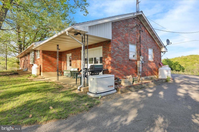 70 Miller Rd, Kutztown, PA 19530 - rear view of house with a lawn and brick siding