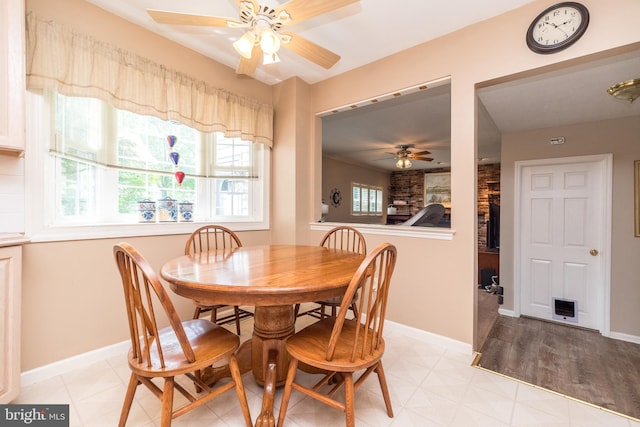 2921 Toll Gate Dr, East Norriton, PA 19403 - dining area with a ceiling fan, a fireplace, and baseboards
