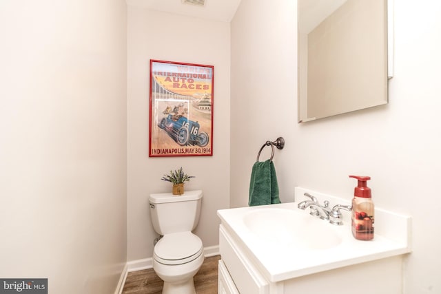 2921 Toll Gate Dr, East Norriton, PA 19403 - bathroom with vanity, toilet, wood finished floors, and baseboards