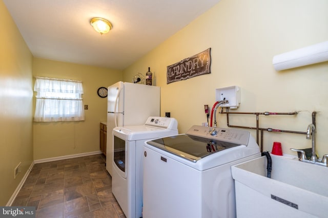 2921 Toll Gate Dr, East Norriton, PA 19403 - laundry area featuring independent washer and dryer, stone finish flooring, and baseboards