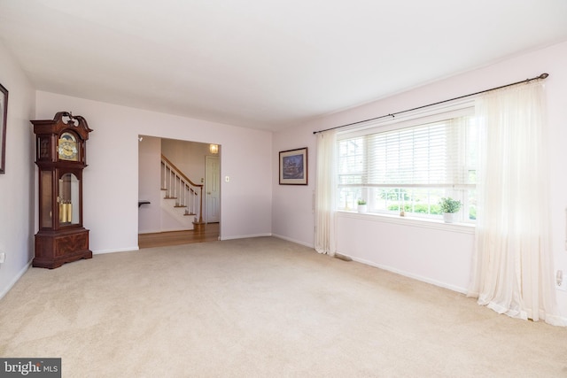 2921 Toll Gate Dr, East Norriton, PA 19403 - carpeted empty room featuring stairs and baseboards