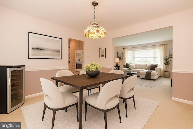 2921 Toll Gate Dr, East Norriton, PA 19403 - dining room featuring wine cooler, light carpet, and baseboards